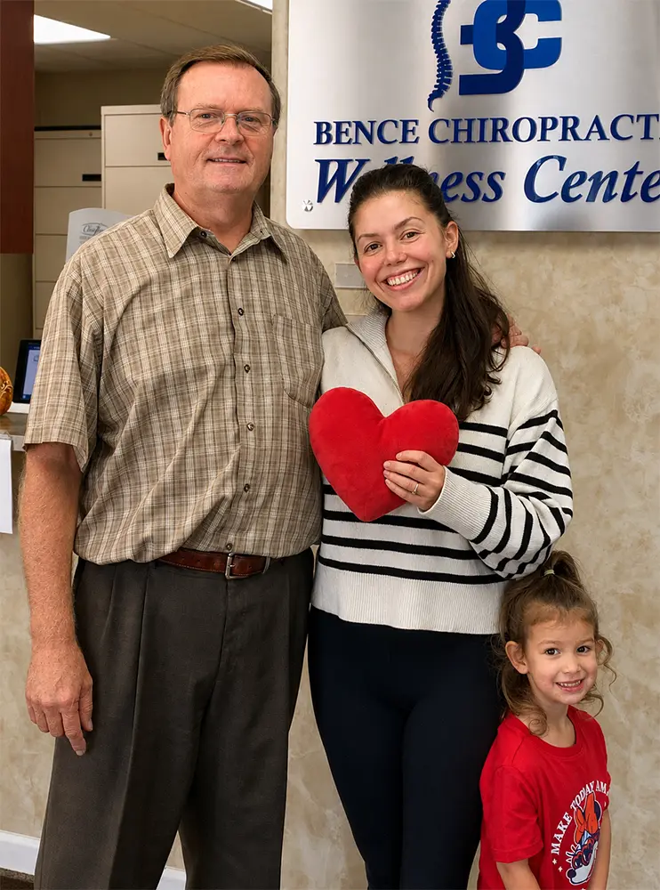 Dr. Pavel Bence with a smiling patient and her daughter at Bence Chiropractic Wellness Center in Macomb, Michigan, celebrating another happy patient experience.